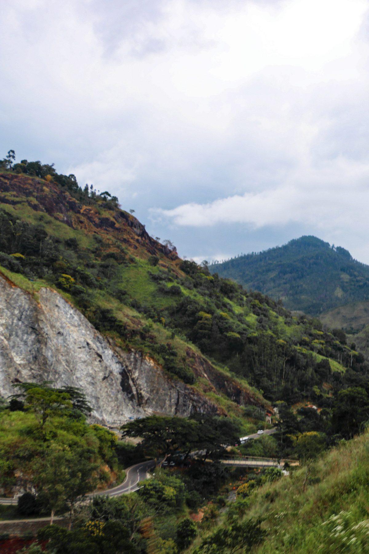 Hills and a winding road near Bandarawela, seen from the train
