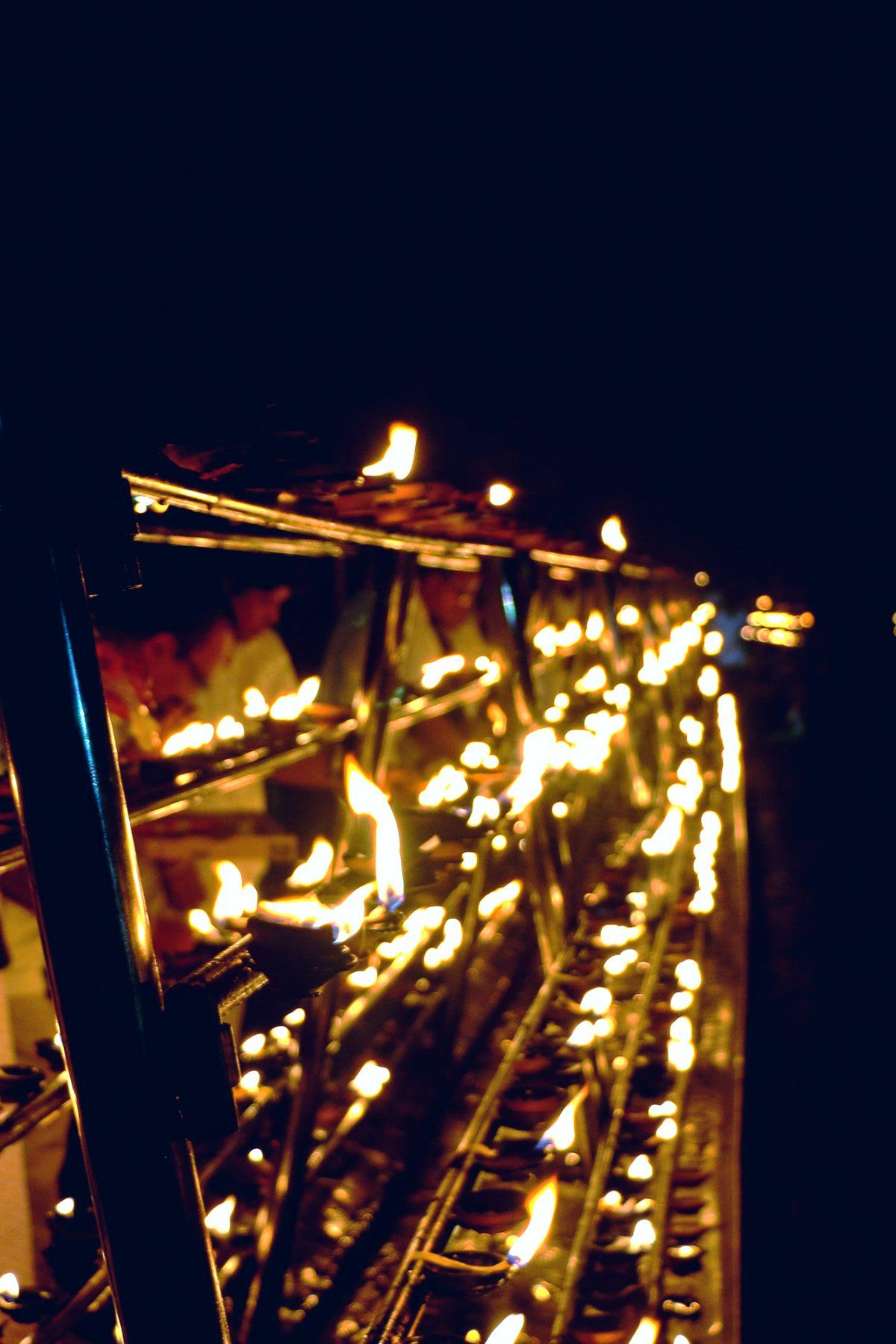 Rows of oil lamps glowing at night