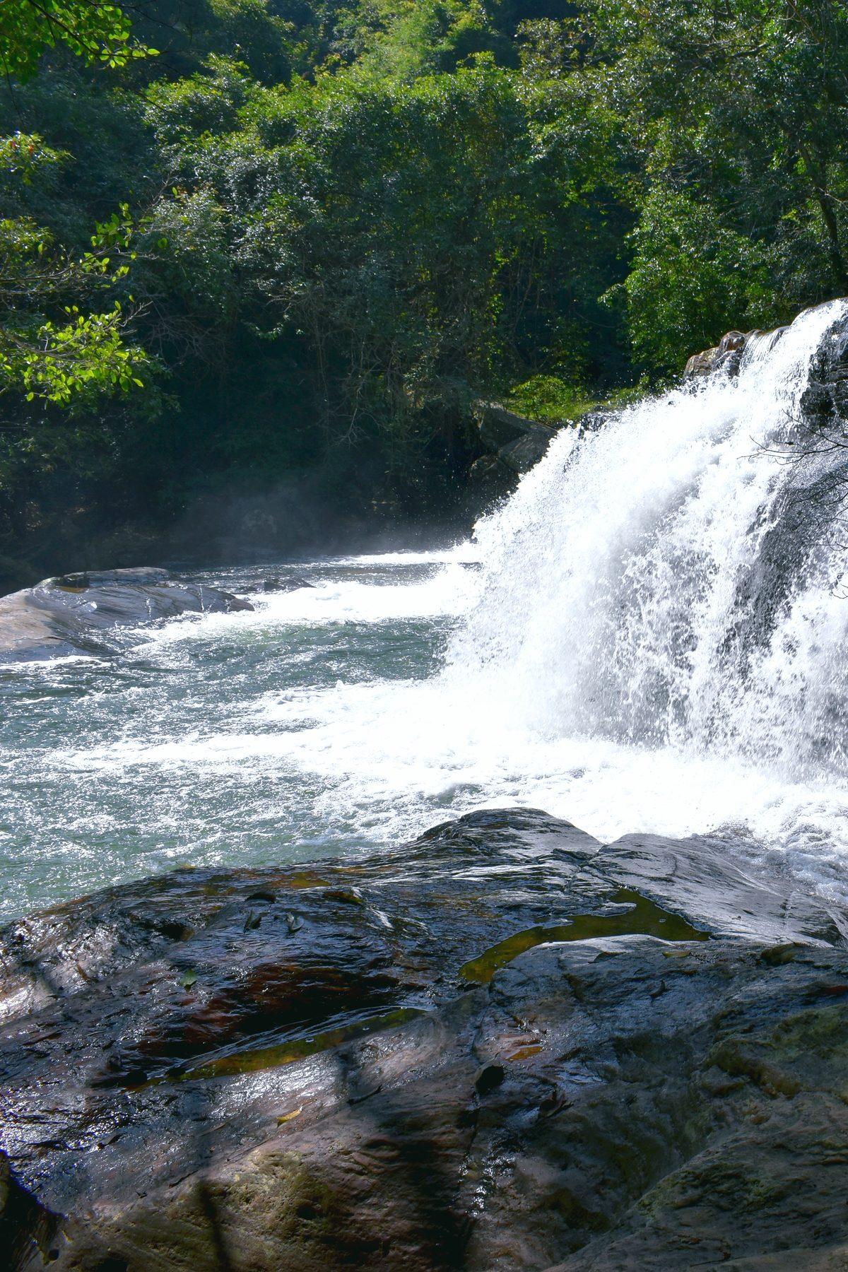 A waterfall pouring over rocks near Mahiyangana village