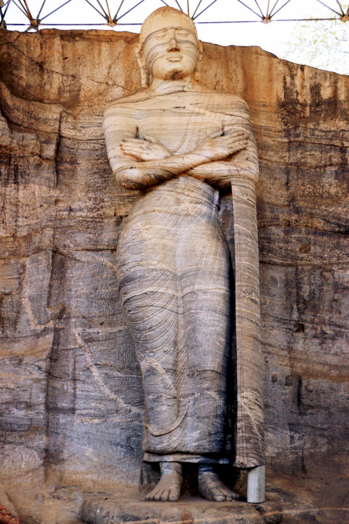 A standing Lord Buddha statue carved into the rock face in Polonnaruwa